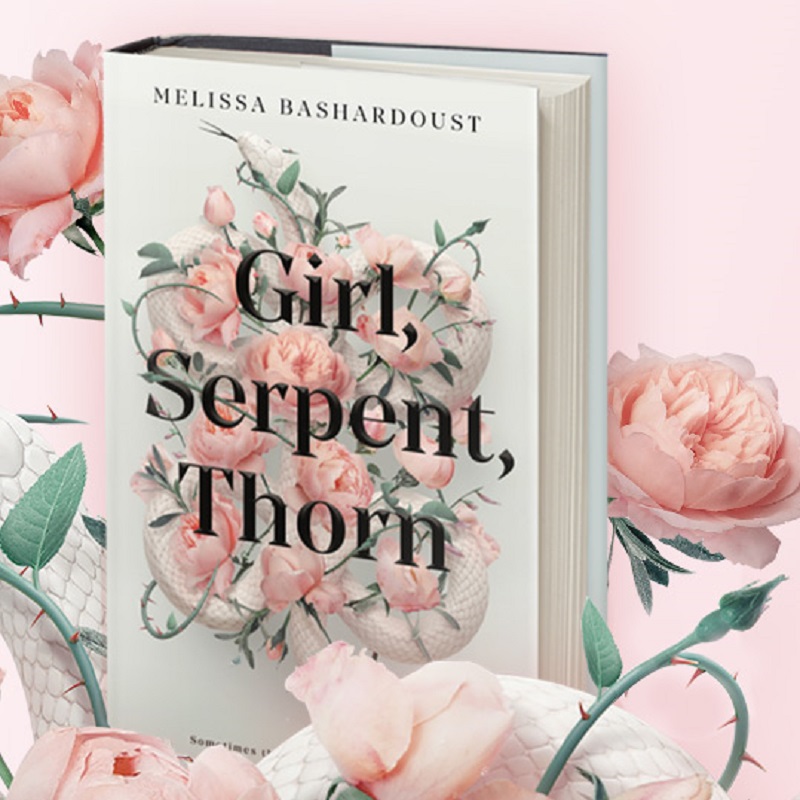 : A copy of Girl, Serpent, Thorn on a white blanket with flowers.