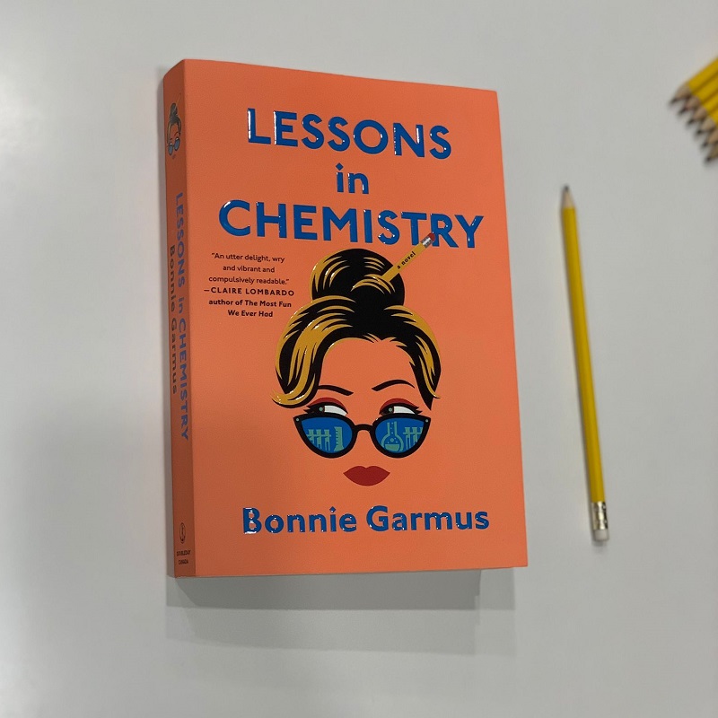 Lessons in Chemistry book against a white background with a pencil